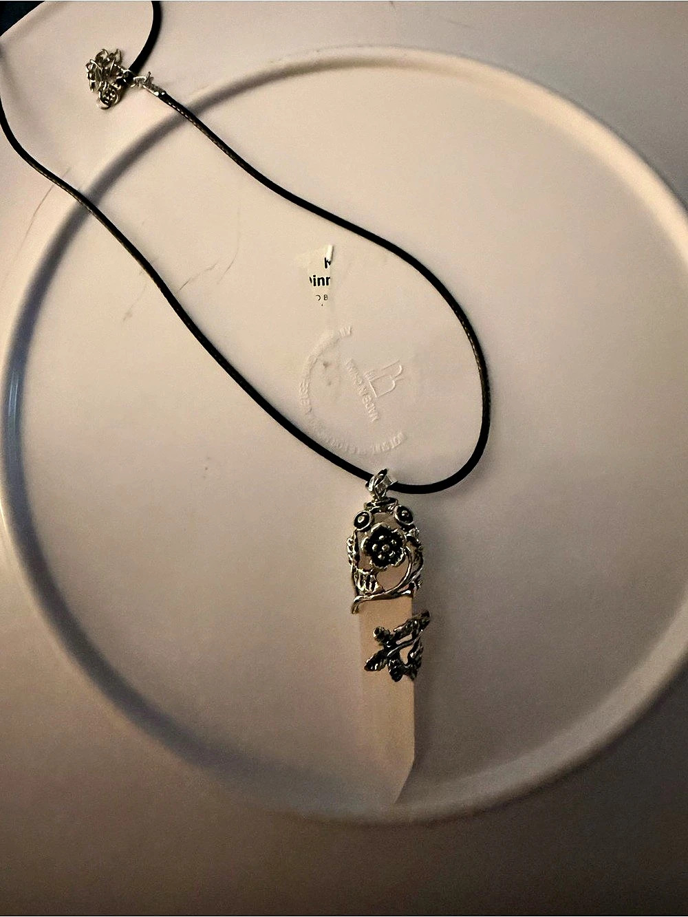 Silver butterfly and flower pendant with rose quartz crystal on black cord
